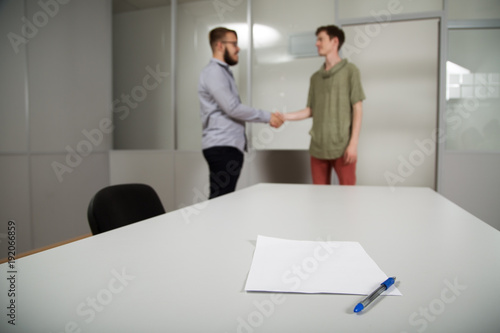 2  people work in the office, talking to, and address the issues of the company, smile and sign documents