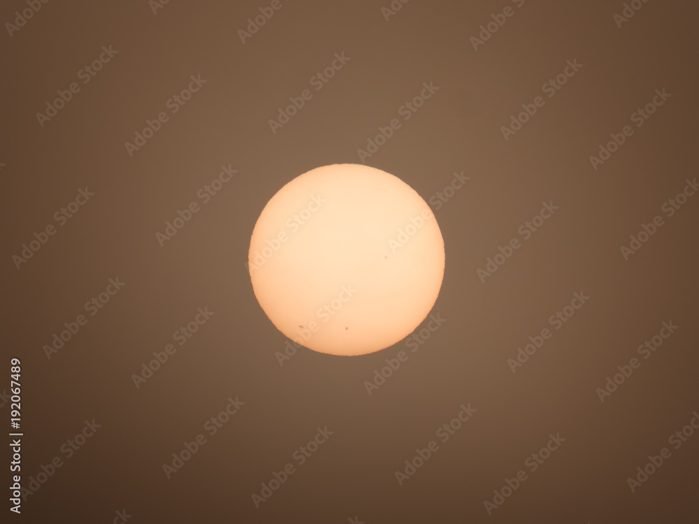 Red sun with sunspots in the morning