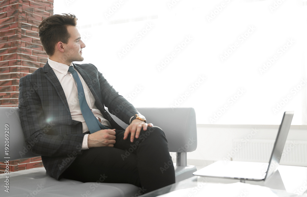 successful businessman sitting on office sofa successful businessman sitting on office sofa