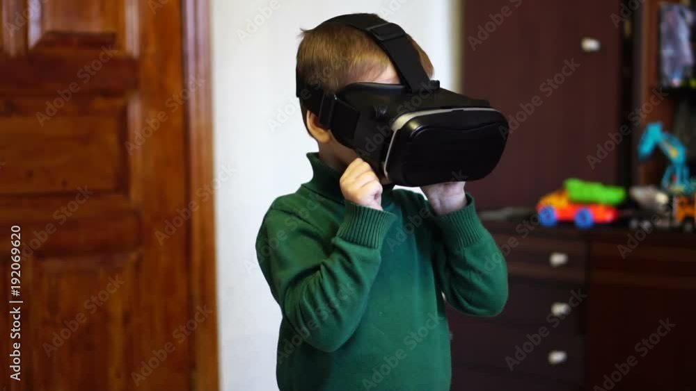 little boy uses virtual reality glasses. Slow motion. close-up little boy uses virtual reality glasses. Slow motion. close-up