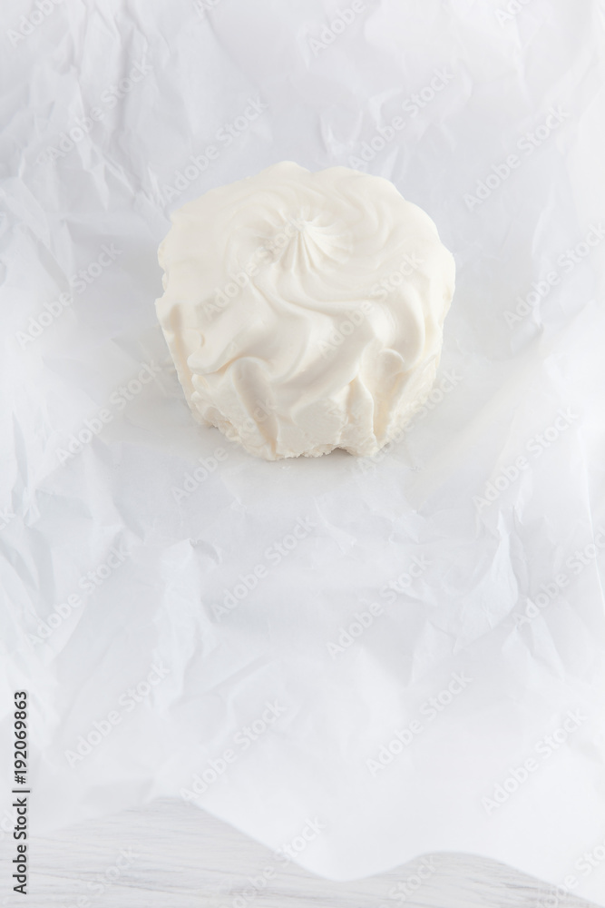 fresh cream cheese on white paper and white wood table can be used as background fresh cream cheese on white paper and white wood table can be used as background