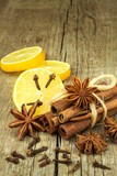 Dried herbs and seasoning. Star of anise, cinnamon sticks and cloves lying on wooden table, seasoning for cooking and baking.