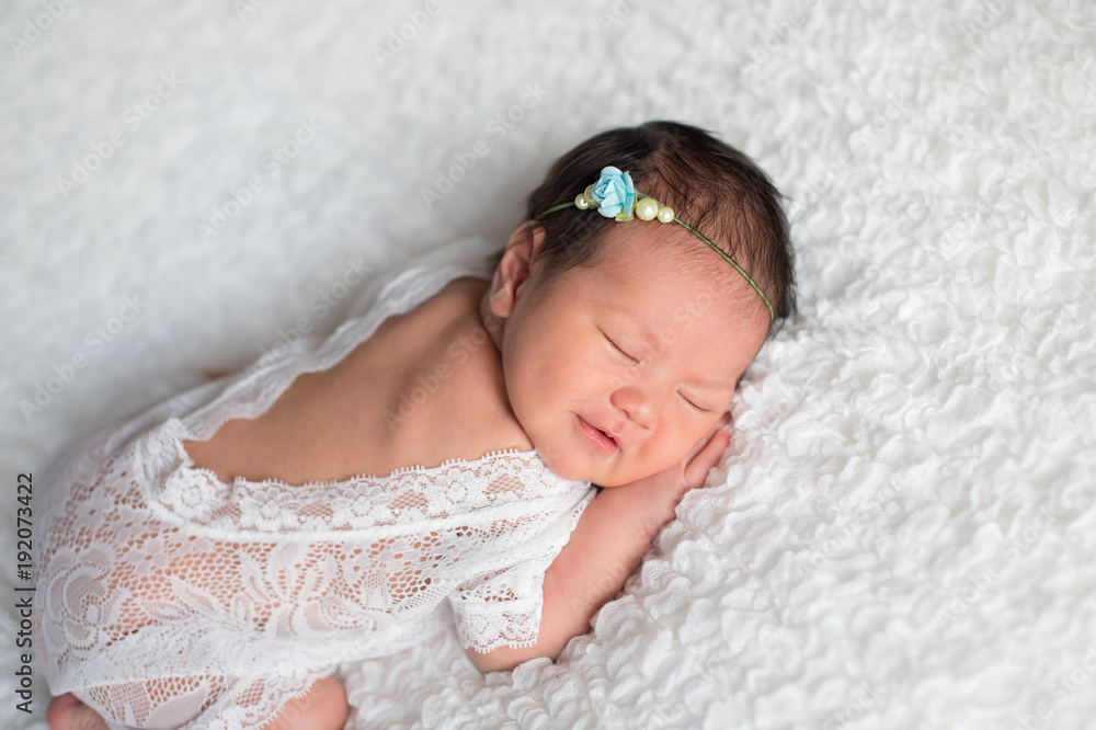 Newborn Baby Girl Wearing a White Lace Romper Newborn Baby Girl Wearing a White Lace Romper