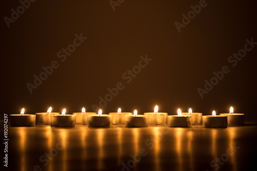 candle flames glowing in the dark.