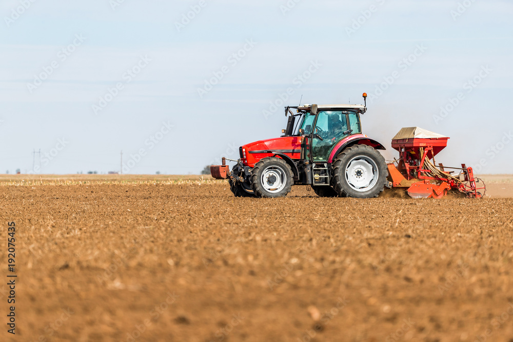 Farmer seeding, sowing crops at field. Sowing is the process of planting seeds in the ground as part of the early spring time agricultural activities. Farmer seeding, sowing crops at field. Sowing is the process of planting seeds in the ground as part of the early spring time agricultural activities.