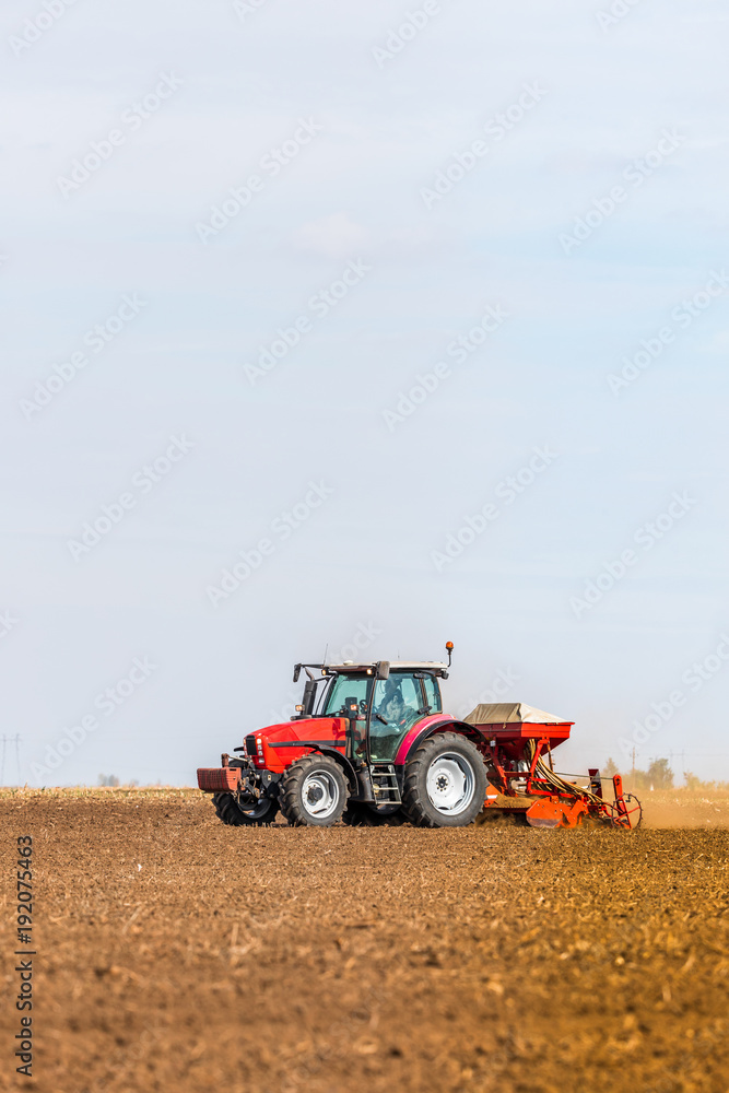 Farmer seeding, sowing crops at field. Sowing is the process of planting seeds in the ground as part of the early spring time agricultural activities. Farmer seeding, sowing crops at field. Sowing is the process of planting seeds in the ground as part of the early spring time agricultural activities.
