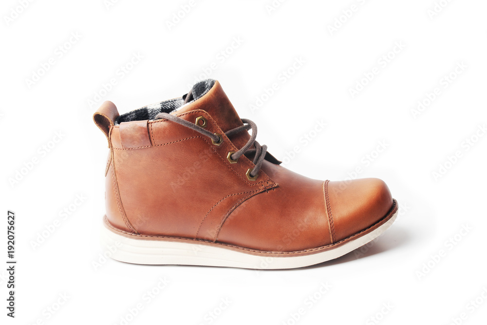 winter brown leather boots on a white background. Modern fashion and style.