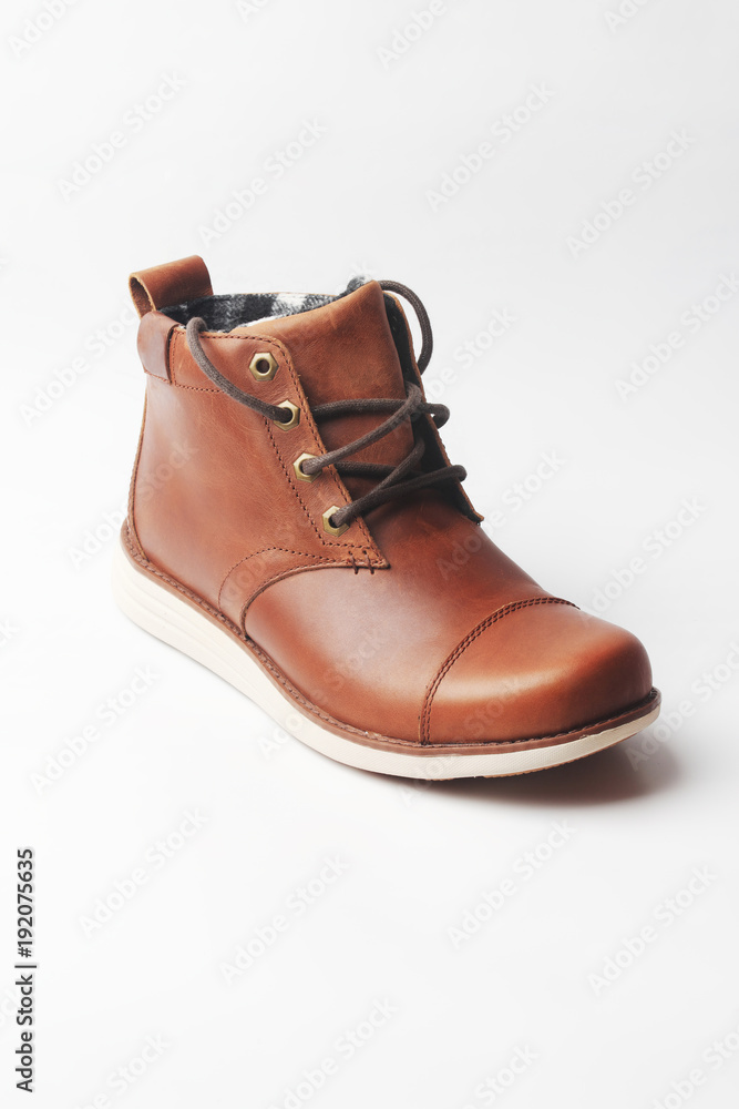 winter brown leather boots on a white background. Modern fashion and style.