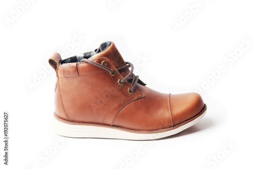 winter brown leather boots on a white background. Modern fashion and style.