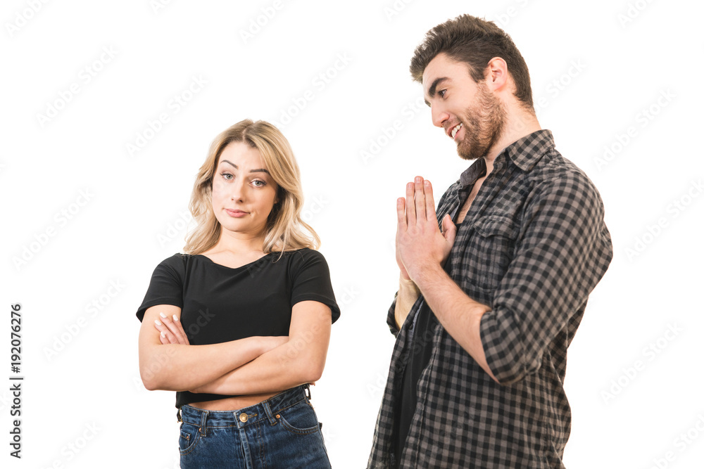 The man apologizes to a woman on the white background The man apologizes to a woman on the white background