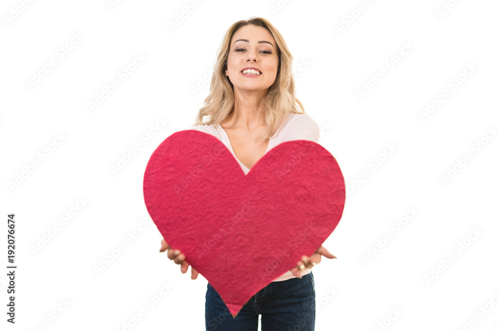 The happy woman holding a heart symbol on the white background The happy woman holding a heart symbol on the white background