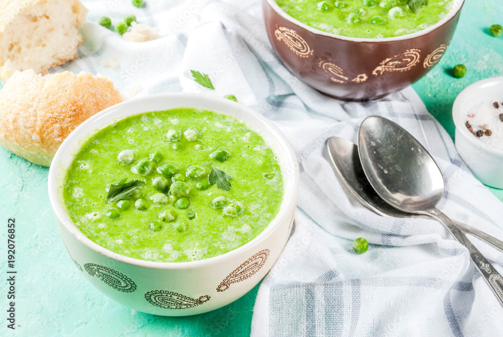 Green pea soup with fresh bread on light blue concrete table, copy space Green pea soup with fresh bread on light blue concrete table, copy space