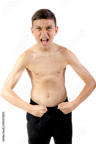 Shirtless teenage boy flexing his muscles