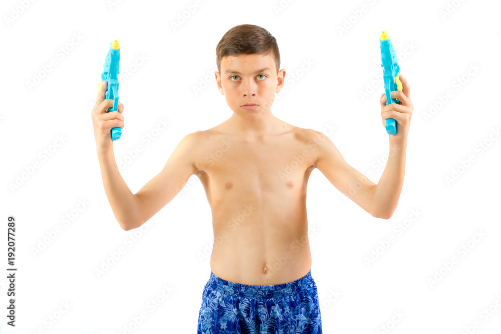 Young teenage boy playing with water guns Young teenage boy playing with water guns