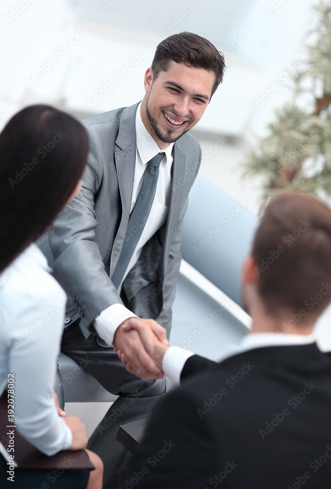 handshake business partners in the lobby of the office. handshake business partners in the lobby of the office.