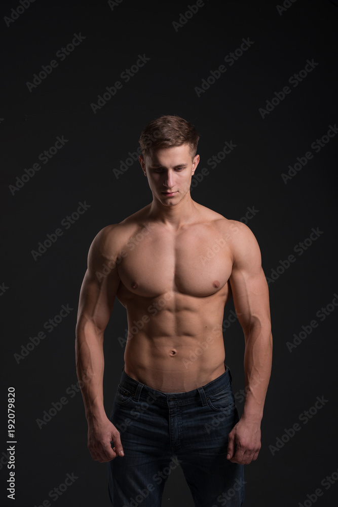man with a sporty physique in the studio on a black background man with a sporty physique in the studio on a black background