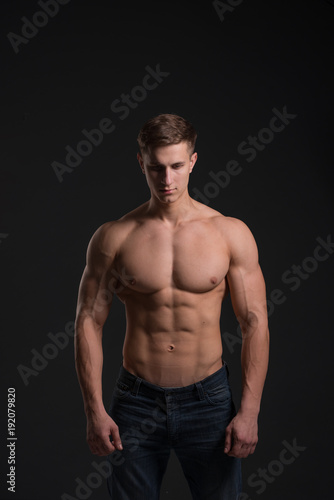 man with a sporty physique in the studio on a black background