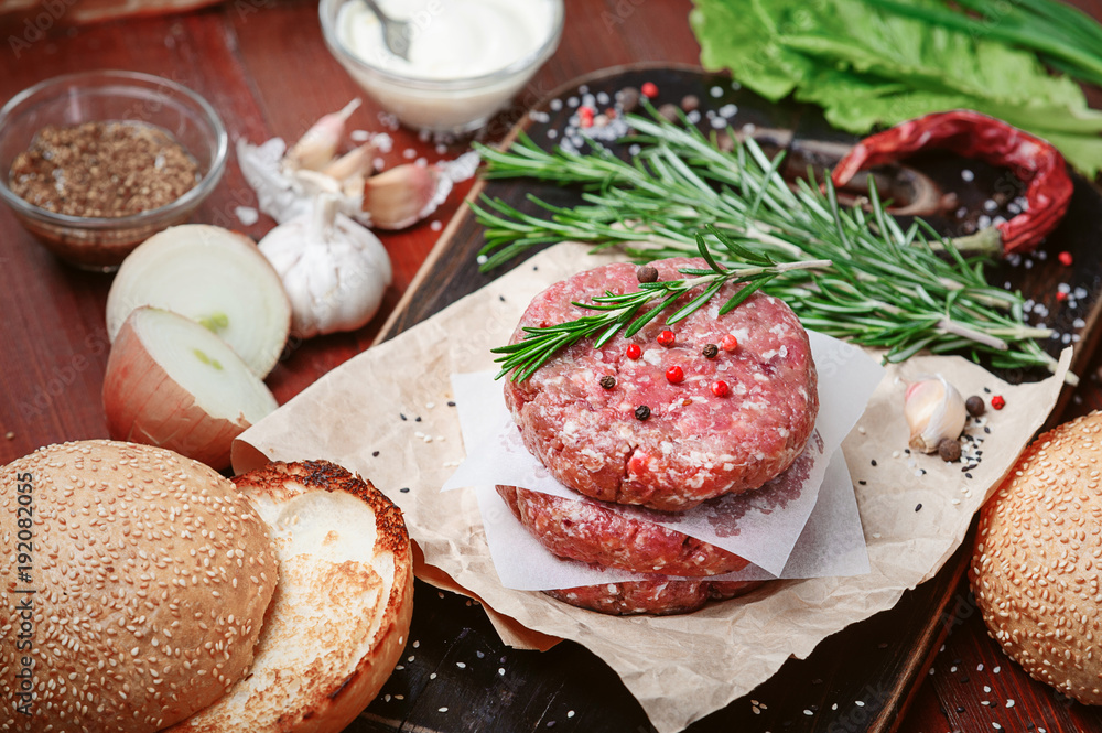 ingredients for a delicious homemade American burger with a juicy large beef chop ingredients for a delicious homemade American burger with a juicy large beef chop