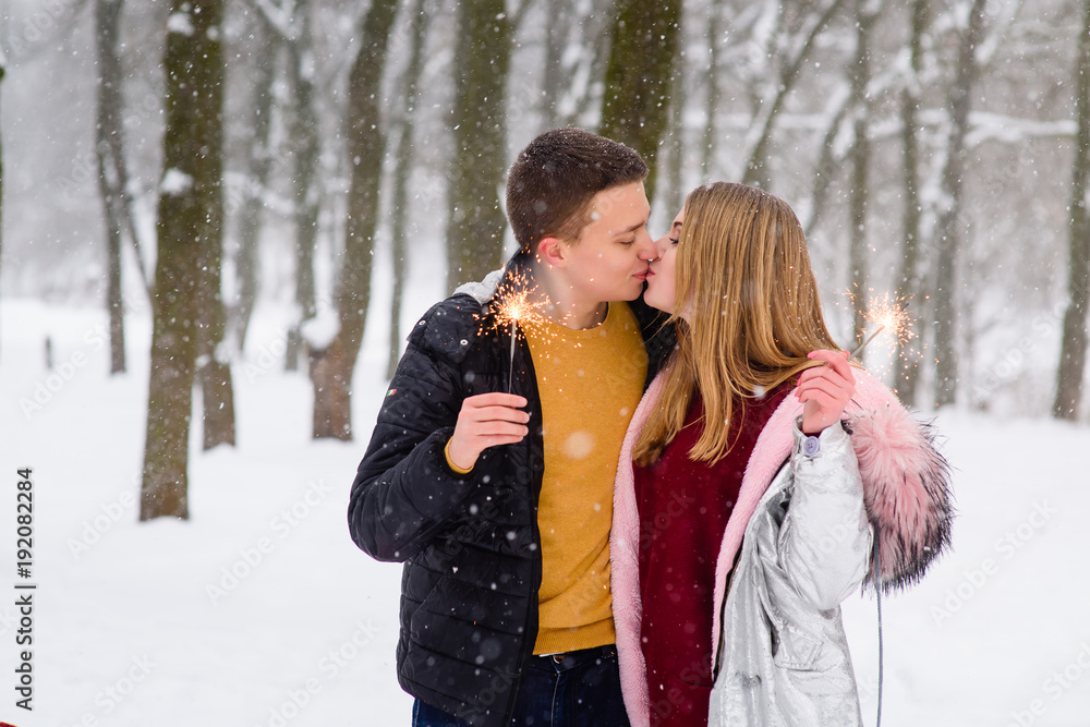 Romantic kiss during snowfall with bengals Romantic kiss during snowfall with bengals