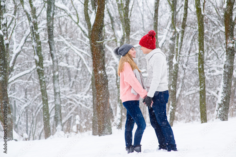 Young couple in winter forest