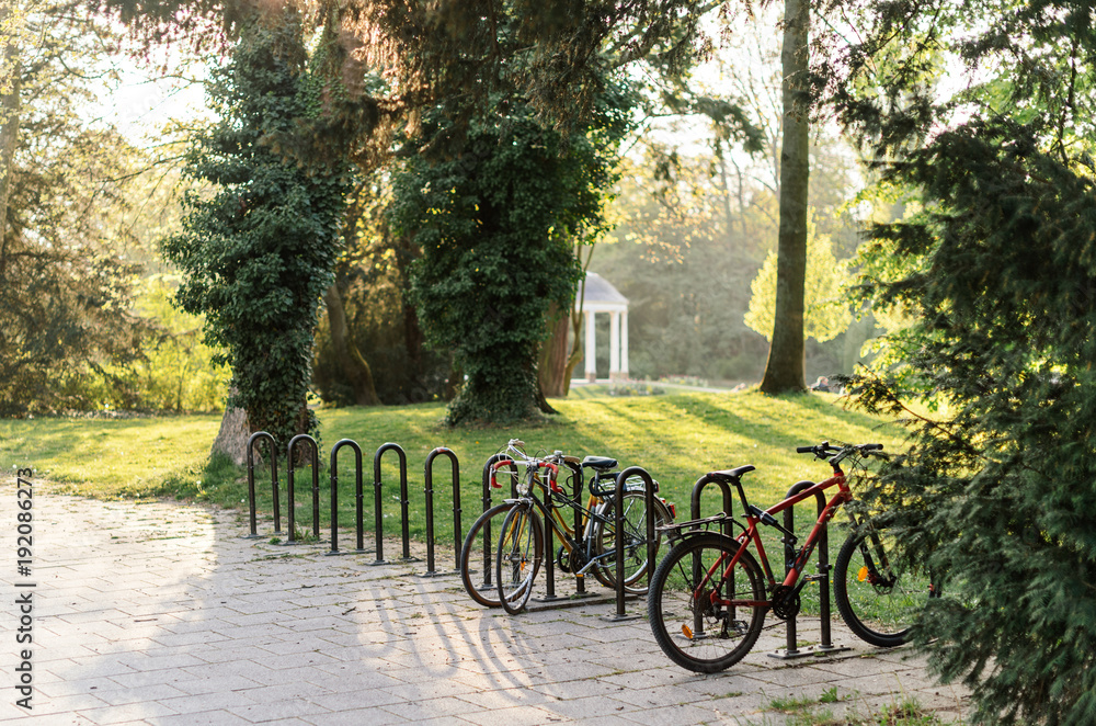 Bicycle parking in French park of Orangerie in Strasbourg on a warm summer day in April 