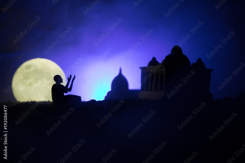 Silhouette of mosque building on toned foggy background. Ramadan Kareem background. Mosque at sunset.