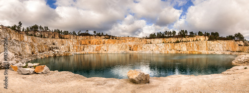 Blue lake in mining industrial crater, acid mine drainage in rock,Spain.