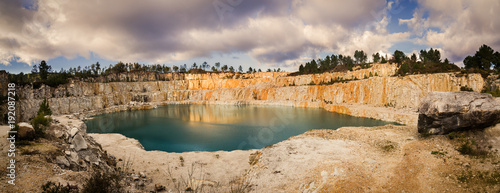 Blue lake in mining industrial crater, acid mine drainage in rock,Spain.