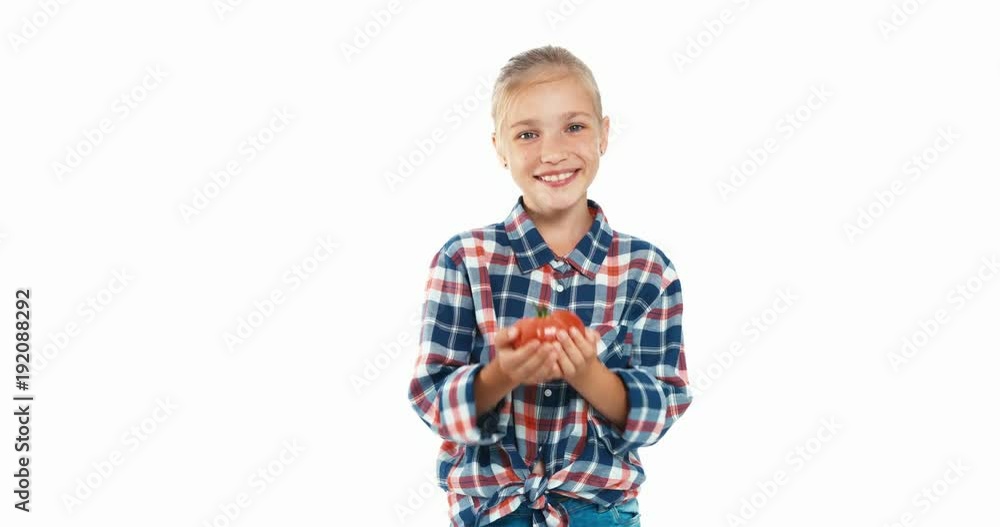 Girl holds in hands big ripe tomato isolated on white Girl holds in hands big ripe tomato isolated on white