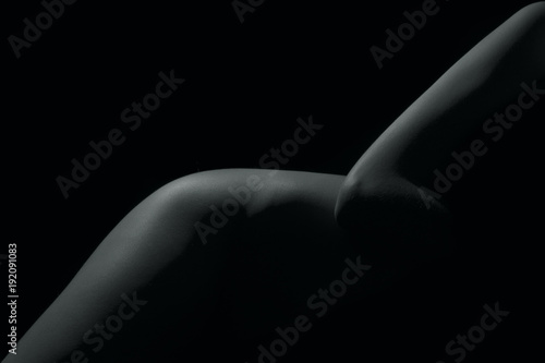 Silhouette of a body part , nude woman isolated on black background