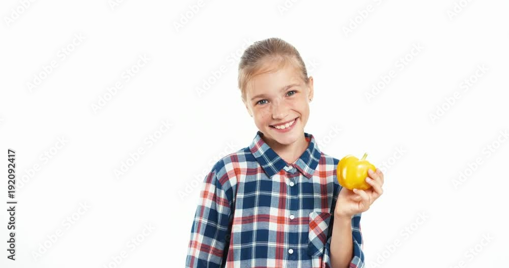 Fresh vegetables for you. Girl holds yellow pepper in her hands Fresh vegetables for you. Girl holds yellow pepper in her hands