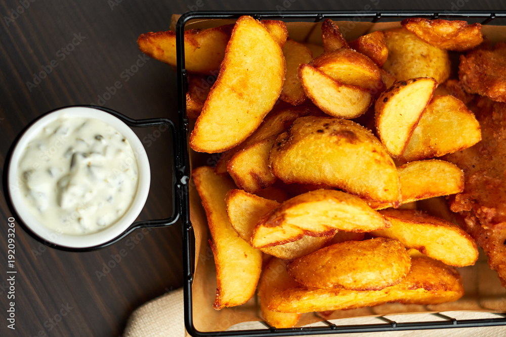 Nuggets and baked potatoes in a beautiful basket with white sauce
