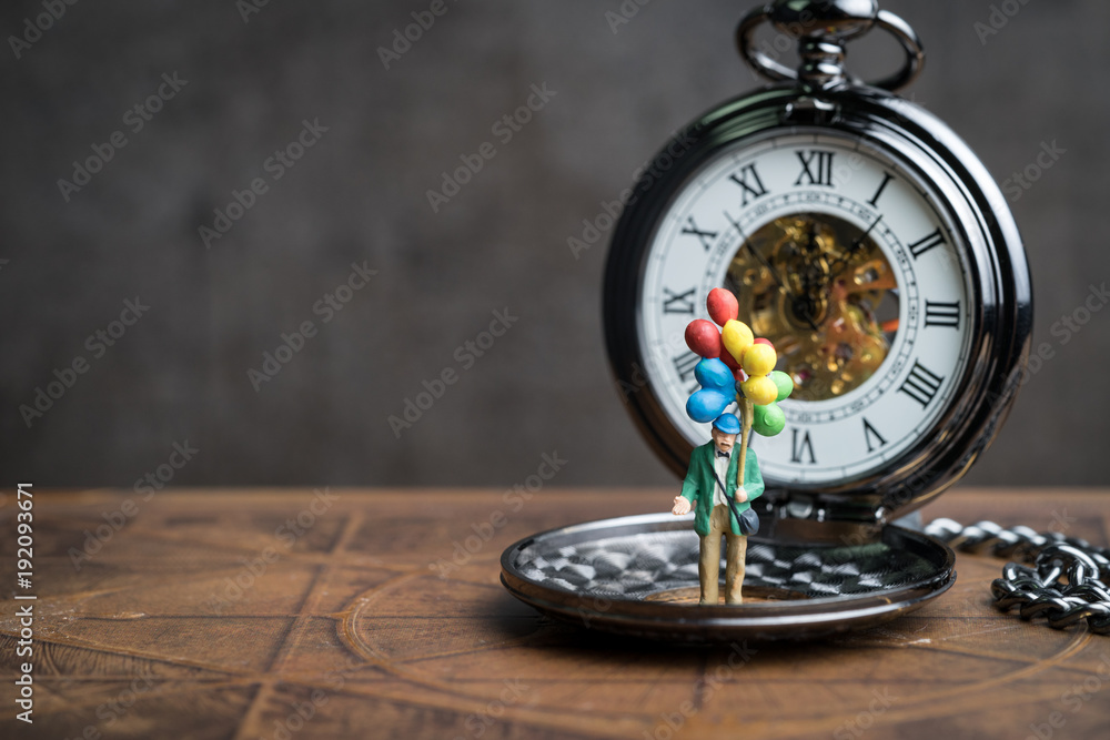 Happy retirement time countdown concept, senior old man holding balloons standing on vintage pocket watch in soft tone, can be use as good health of aged people Happy retirement time countdown concept, senior old man holding balloons standing on vintage pocket watch in soft tone, can be use as good health of aged people