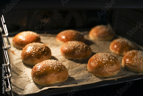 Tasty buns with sesame. Freshly Baked Buns. Hot, fresh from the oven hamburger buns. Homemade Brioche Hamburger Buns