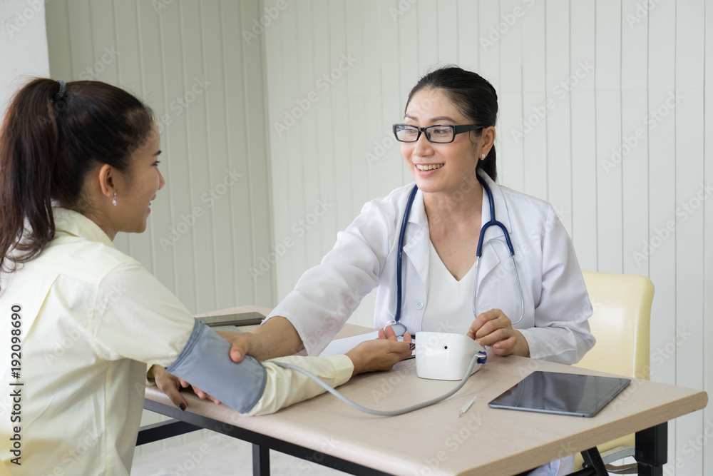 Fototapeta premium Female doctor meeting with a patient in the office, she is giving a prescription to woman, healthcare and medicine concept.Doctor talking patient .