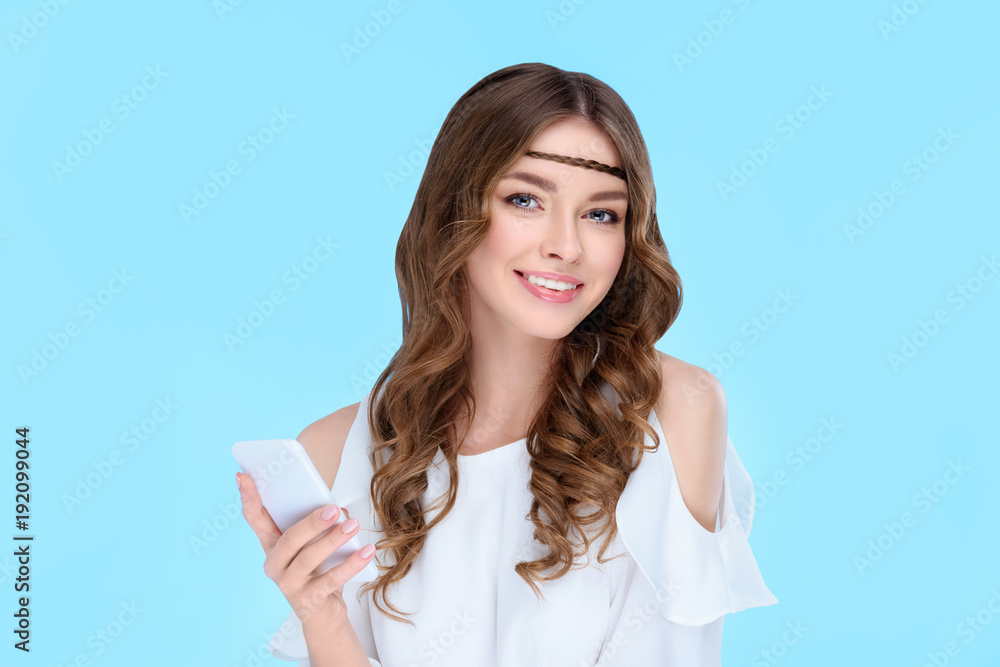 beautiful young woman with smartphone isolated on blue beautiful young woman with smartphone isolated on blue