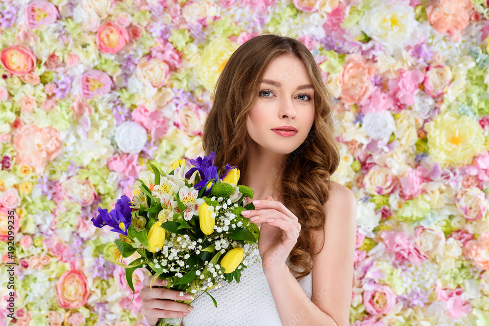 beautiful young woman with curly hair holding floral bouquet beautiful young woman with curly hair holding floral bouquet
