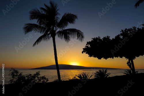 Sunset over Lanai from Baby Beach on the island of Maui.