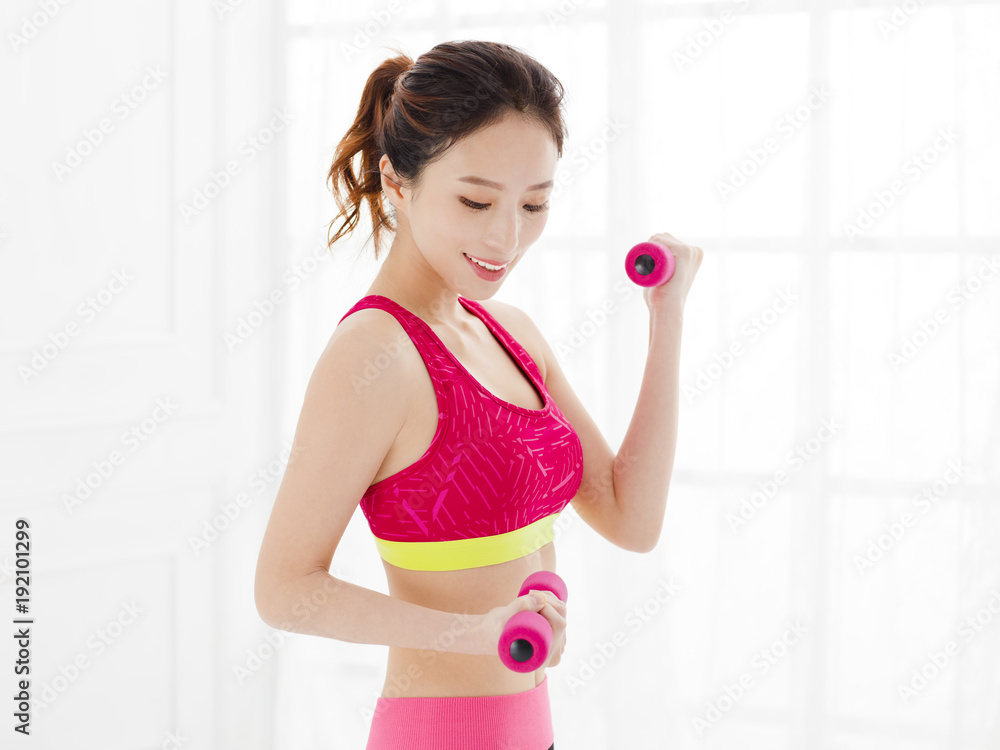 happy young woman with dumbbells working out happy young woman with dumbbells working out