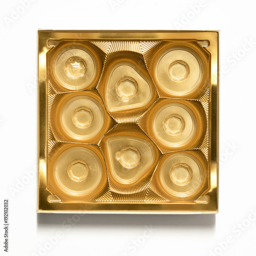 Empty gold chocolate box - plastic chocolate container - isolated on white