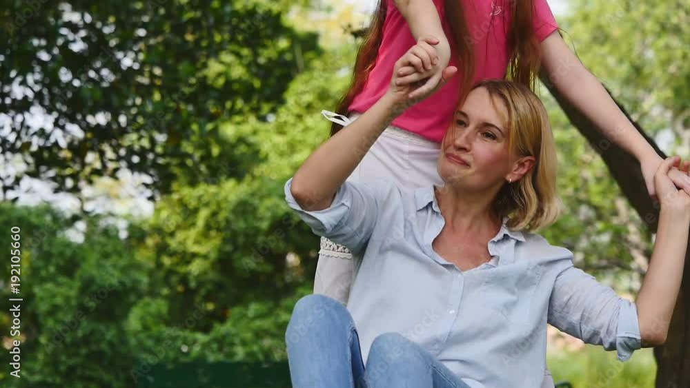 Mother and daughter having fun together in a park. Family and lifestyle concept Mother and daughter having fun together in a park. Family and lifestyle concept