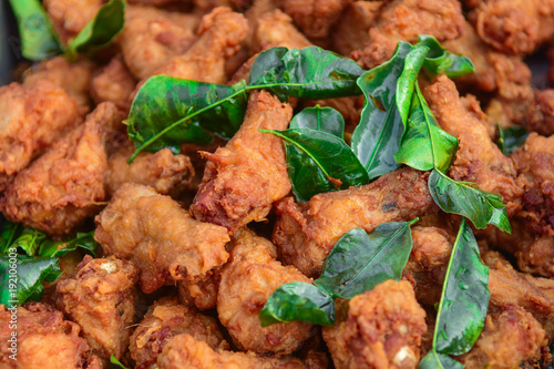 Chicken drumstick and Lime leaf sprinkle on top, close up view photo