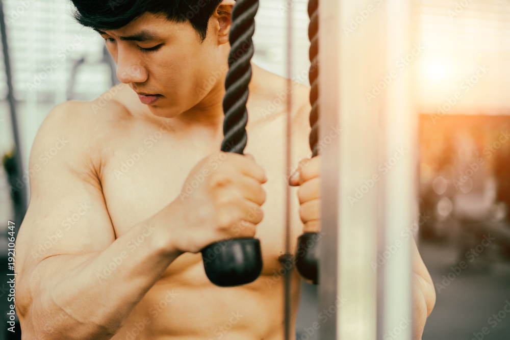 Obraz premium strong fitness man posing muscular body and doing exercises for bodybuilder in the gym, fitness concept, sport concept