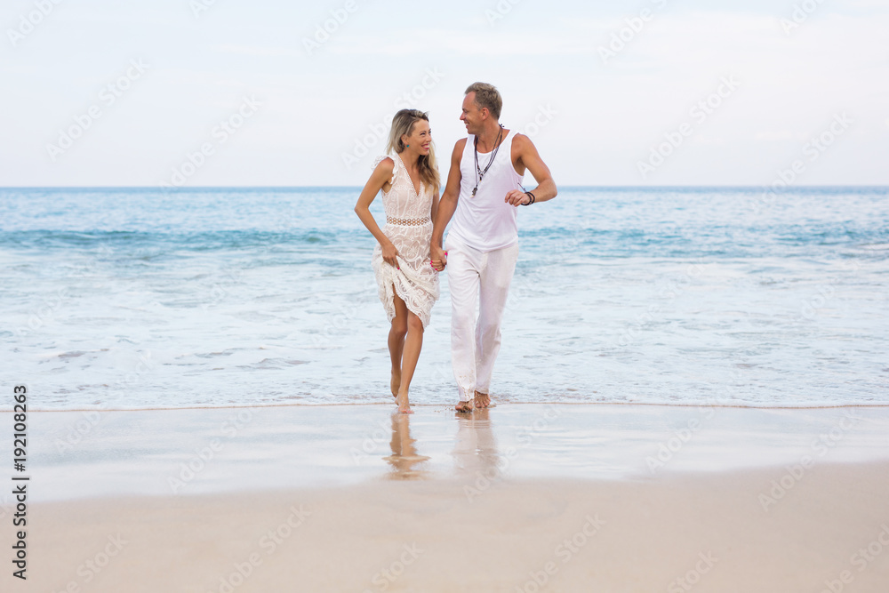 Couple on vacation walking on the beach