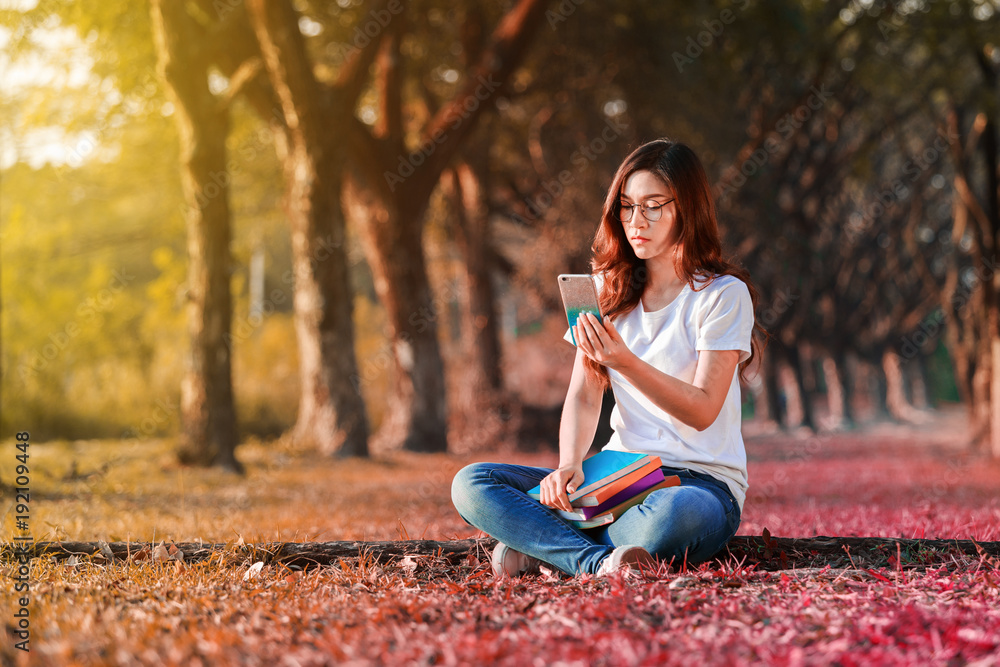 woman using moblie phone in park woman using moblie phone in park