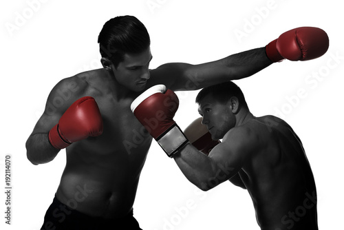 Young boxers fighting on white background