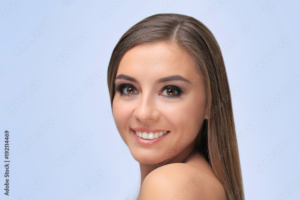 Beautiful young woman with eyelash extensions on light background Beautiful young woman with eyelash extensions on light background