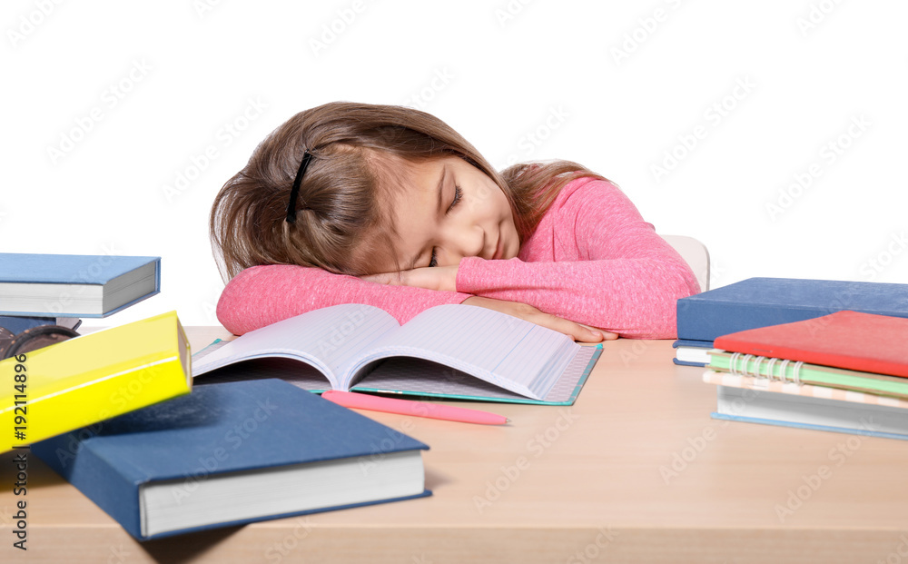 Sleeping little girl tired of doing homework against white background Sleeping little girl tired of doing homework against white background