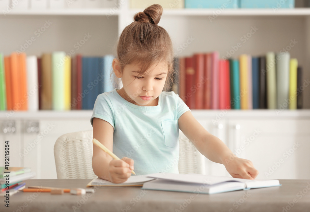 Cute little girl doing homework indoors Cute little girl doing homework indoors
