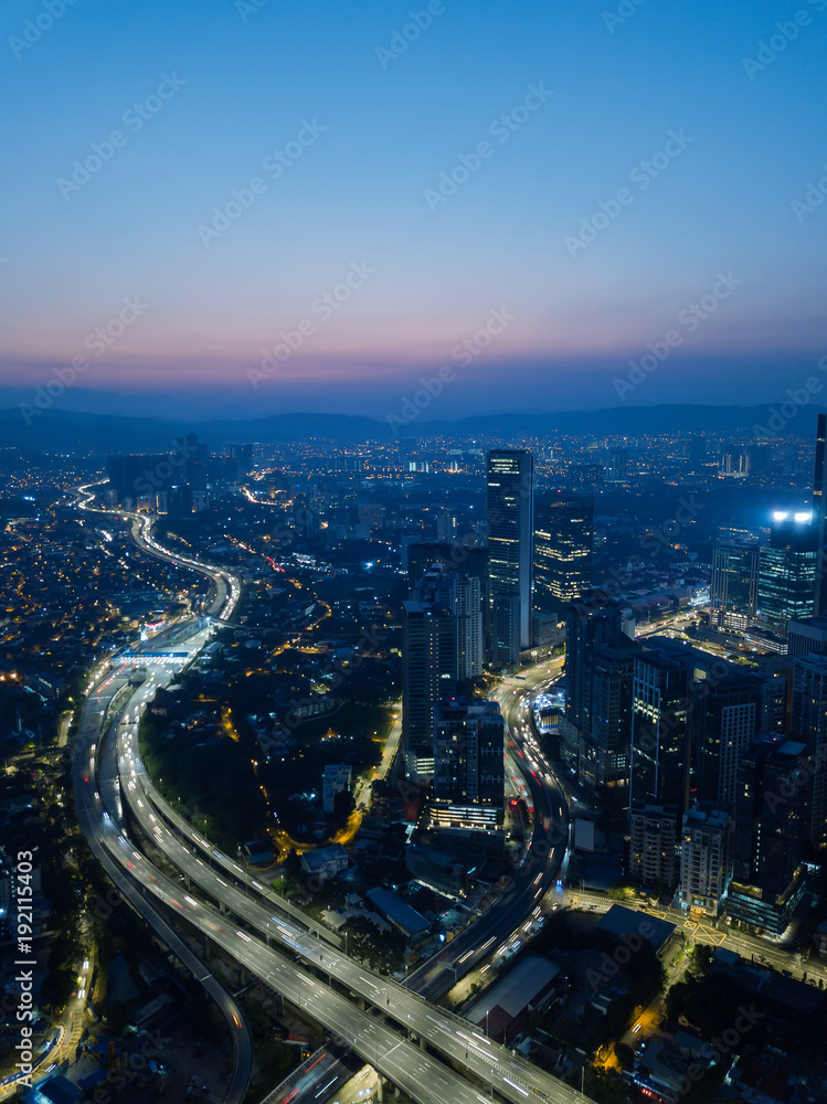 Fototapeta premium Vertical aerial view in the middle of Kuala Lumpur cityscape skyline .Night scene before sunrise , Malaysia .